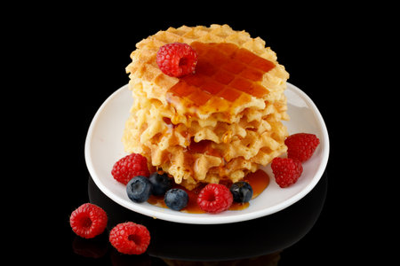 Appetizing food. sweet dessert. Waffles with honey and berriesの写真素材
