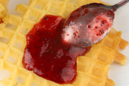 Belgian waffles with raspberry jam. Belgian waffles with berriesの写真素材