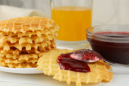 Belgian waffles with raspberry jam. Belgian waffles with berriesの写真素材