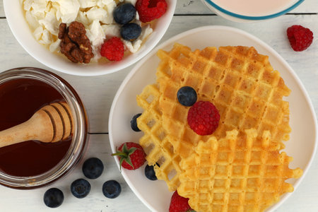 Waffles with honey and berries for breakfastの写真素材