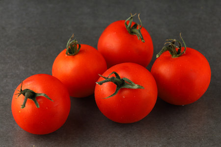 cherry tomatoes on a dark backgroundの写真素材