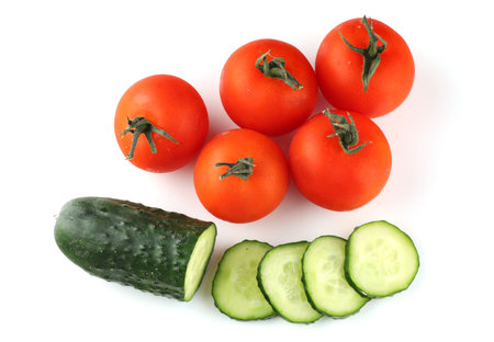 Tomatoes and cucumbers isolate top viewの写真素材