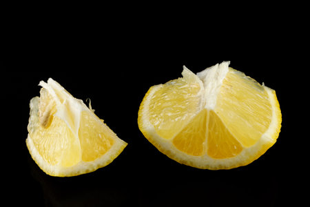 Piece of lemon isolate on blackの写真素材