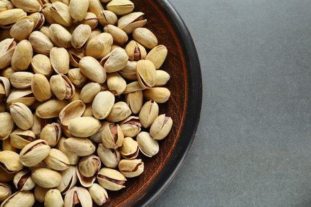 Pistachio nuts in a plate. Place for textの写真素材