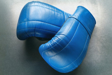 Blue boxing gloves on concreteの写真素材