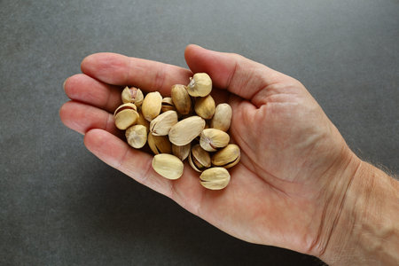 Pistachio nuts several in handの写真素材