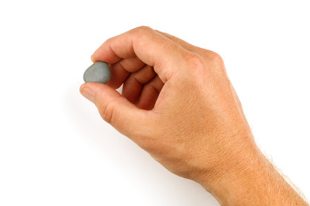 Small stone in hand isolateの写真素材