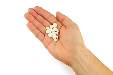 White pills in hand isolateの写真素材