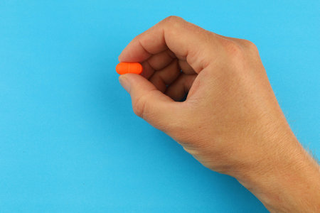 Orange pill in handの写真素材