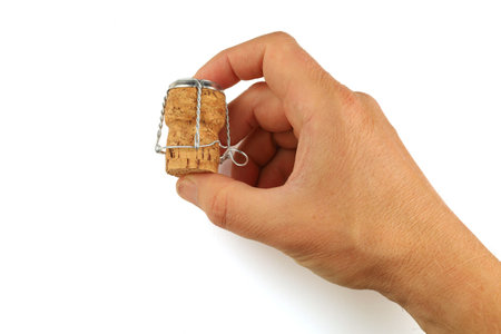 Hands hold the cork from the sparkling wineの写真素材