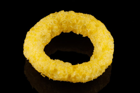 Corn rings. Yellow snacks on a black backgroundの写真素材