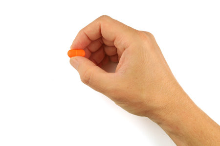 Orange pill in handの写真素材