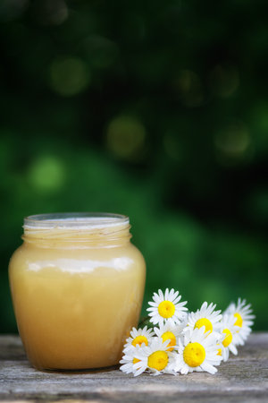 Honey in a jar on the pass.の写真素材
