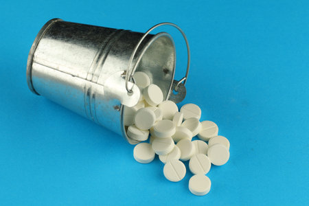 White medical round pills in a bucketの写真素材