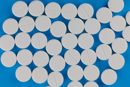 White medical round pills in a heap a lotの写真素材