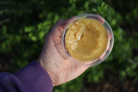 garden wax in the jar in handの写真素材