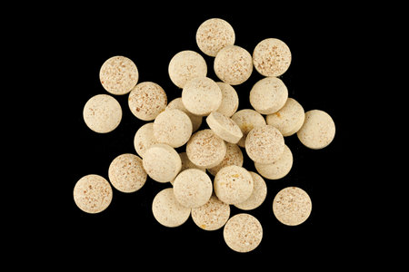Brewer's yeast in tablets black backgroundの写真素材