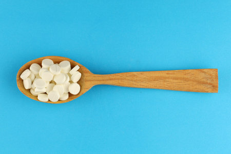 White medical round pills in a spoonの写真素材