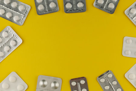 Tablets in a blister on yellow background. place for text cope spaceの写真素材