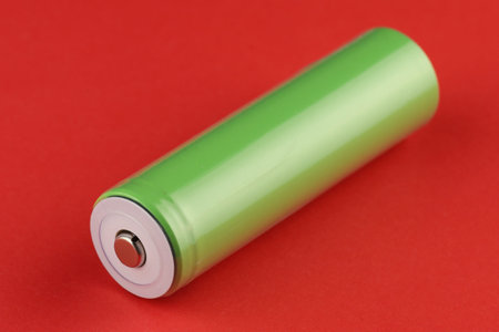 18650 battery green on red backgroundの写真素材