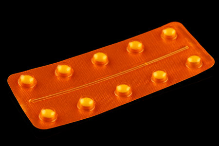 Yellow pills in a yellow blisterの写真素材