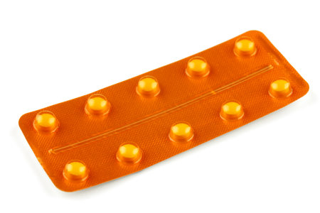 Yellow pills in a yellow blisterの写真素材