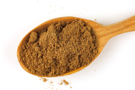 Ground coriander seasoning in a wooden spoon isolateの写真素材