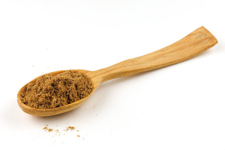 Ground coriander seasoning in a wooden spoon isolateの写真素材
