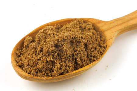 Ground coriander seasoning in a wooden spoon isolateの写真素材