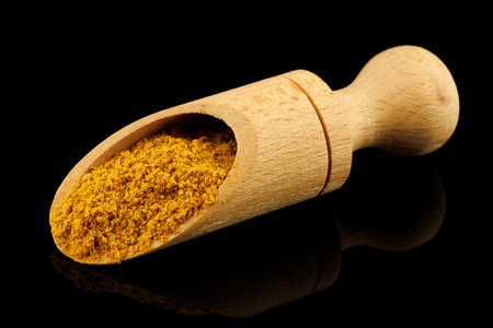 Curry powder seasoning in a scoopの写真素材