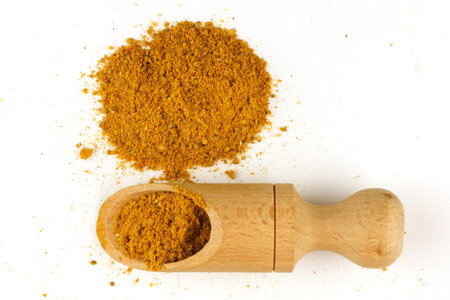 Curry powder seasoning in a scoopの写真素材