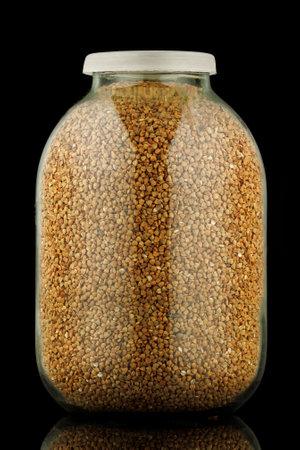 Buckwheat in a glass jar black backgroundの写真素材