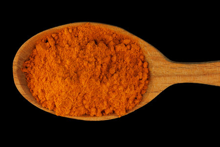 Turmeric curcuma spice in a wooden spoonの写真素材