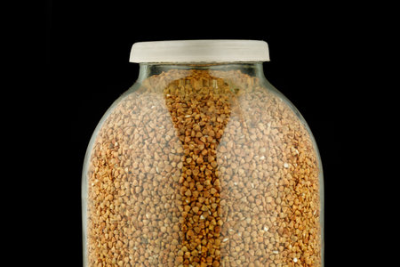 Buckwheat in a glass jar black backgroundの写真素材