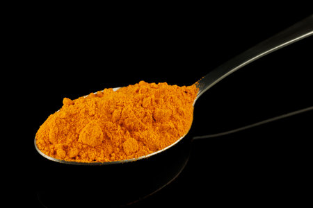 Turmeric spice in a metal spoonの写真素材