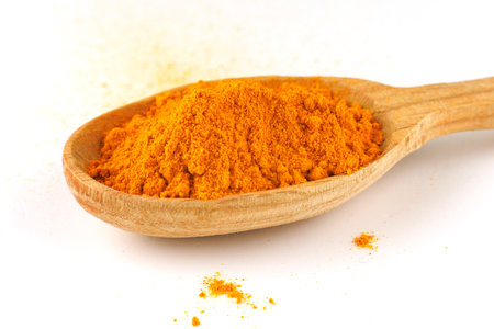 Turmeric spice in a wooden spoonの写真素材