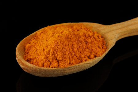 Turmeric spice in a wooden spoonの写真素材