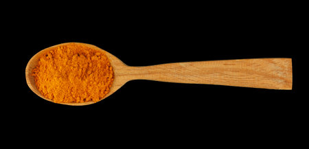 Turmeric spice in a wooden spoonの写真素材