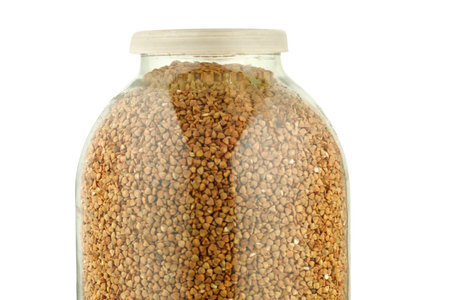 Buckwheat in a glass jar isolateの写真素材