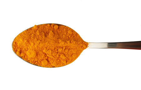 Turmeric curcuma spice in a metal spoonの写真素材