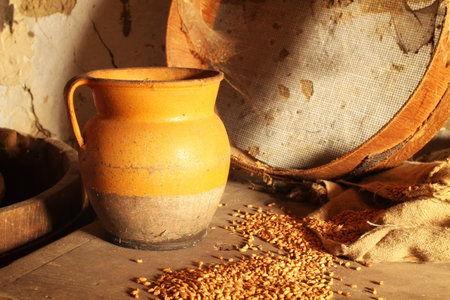 Jug, sieve and grain in an old barnの写真素材