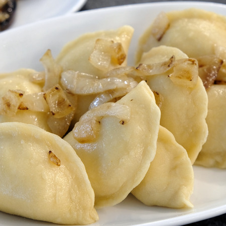 Boiled Dumplings with Onions on a white plate. Food photograph.の写真素材