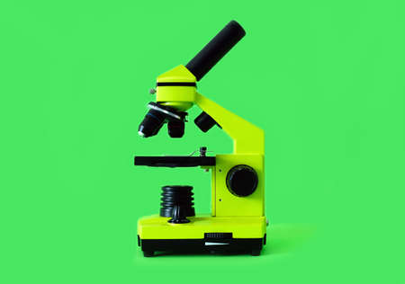 Microscope on a bright green background. High quality photo.の写真素材