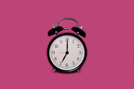 Clock alarm clock on a bright pink backgroundの写真素材