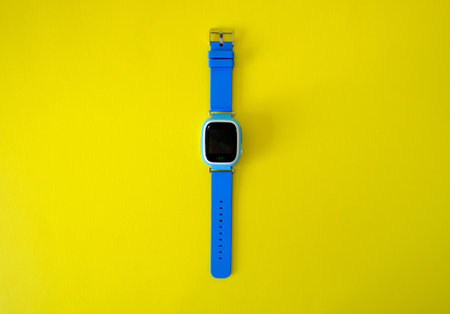 Wristwatch with GPS on a bright yellow background. Childrens GPS clockの写真素材