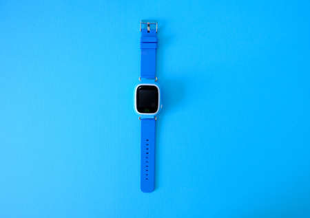 Wristwatch with GPS on a bright blue background. Childrens GPS clock
