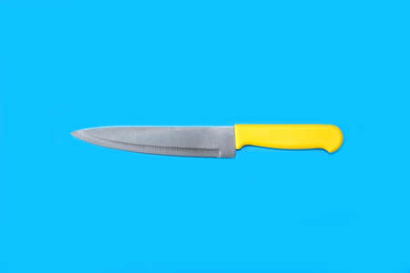 Kitchen knife on a bright blue background. Minimal artの写真素材