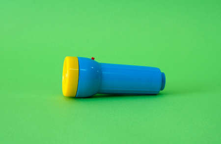 Flashlight on a bright green backgroundの写真素材