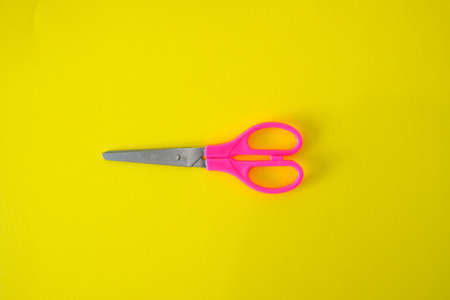 Scissors on a bright yellow backgroundの写真素材
