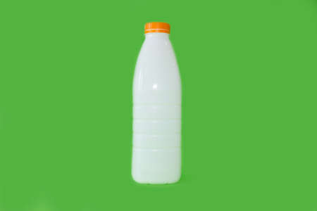 Bottle for milk on a bright green backgroundの写真素材